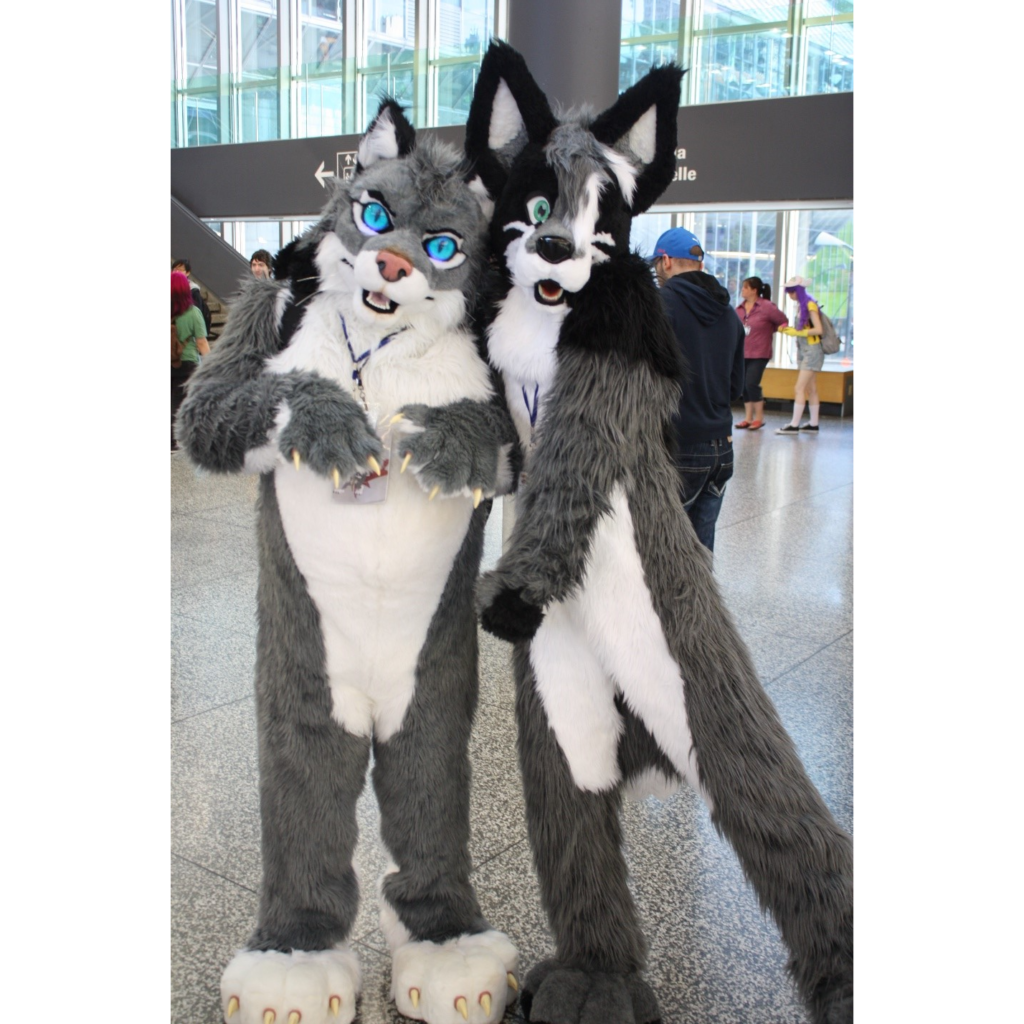 Two people dressed as furries in a public indoor area.