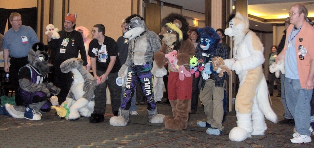 Furries standing in line indoors.